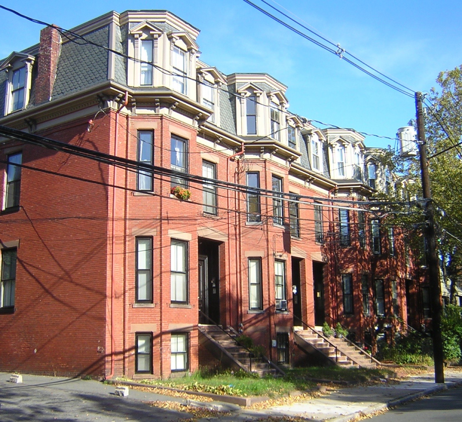 Attached mansard-roofed brick rowhouses on Central Street in Somerville