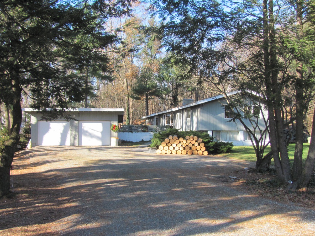 A low Peacock Farm house among pines, a typical setting for a Lexington bathroom remodel